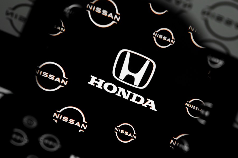 A Honda logo surrounded by Nissan logos