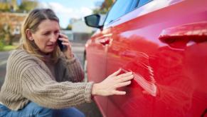 A driver calls the police and her insurance provider after a hit-and-run accident.