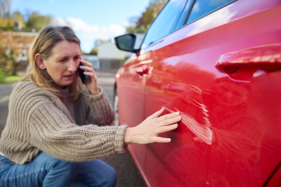 A driver calls the police and her insurance provider after a hit-and-run accident.