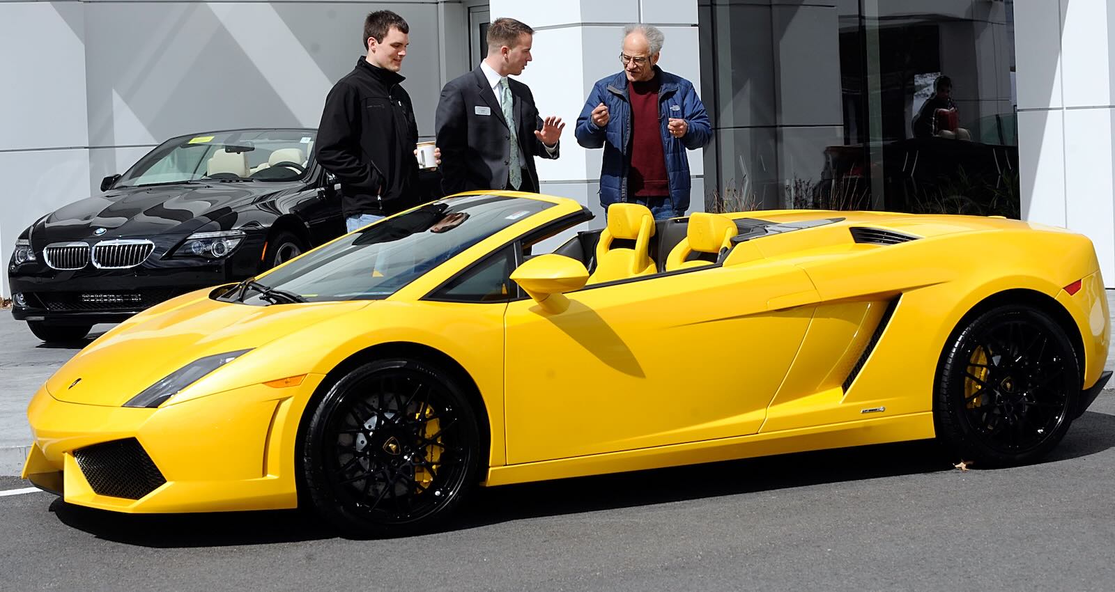 Lamborghini salesman shows a yellow Gallardo before a test drive.