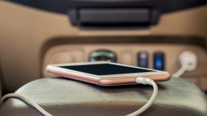 Phone charging on a cable in an Uber car.