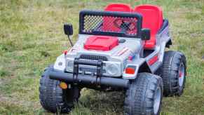 Silver Power Wheels Jeep parked on a green lawn