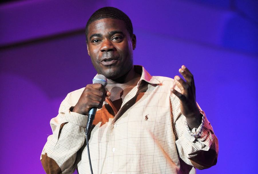 Tracy Morgan holds a microphone on stage.