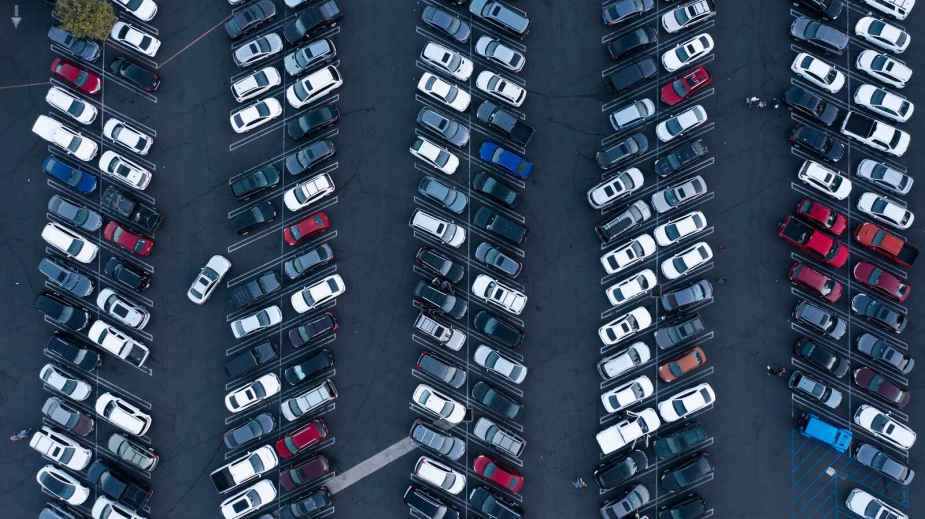 rows of cars parked in lot from an aerial view