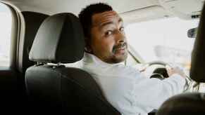 Male driver looking back