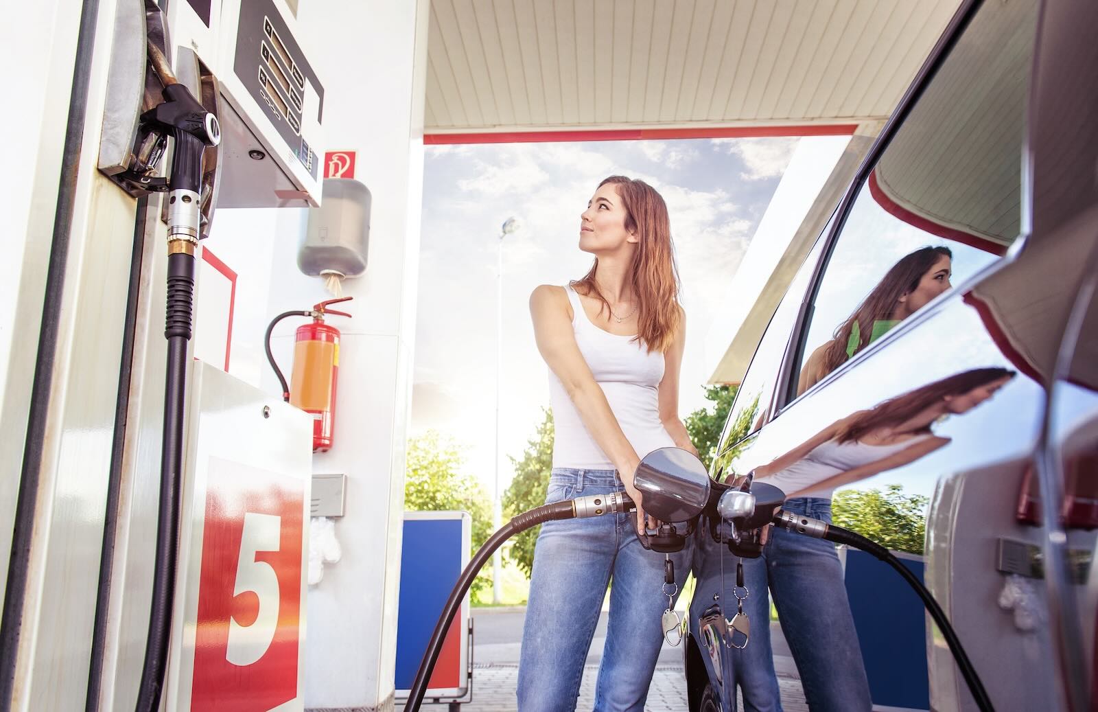 Woman refuels her car at a Massachusetts gas station.