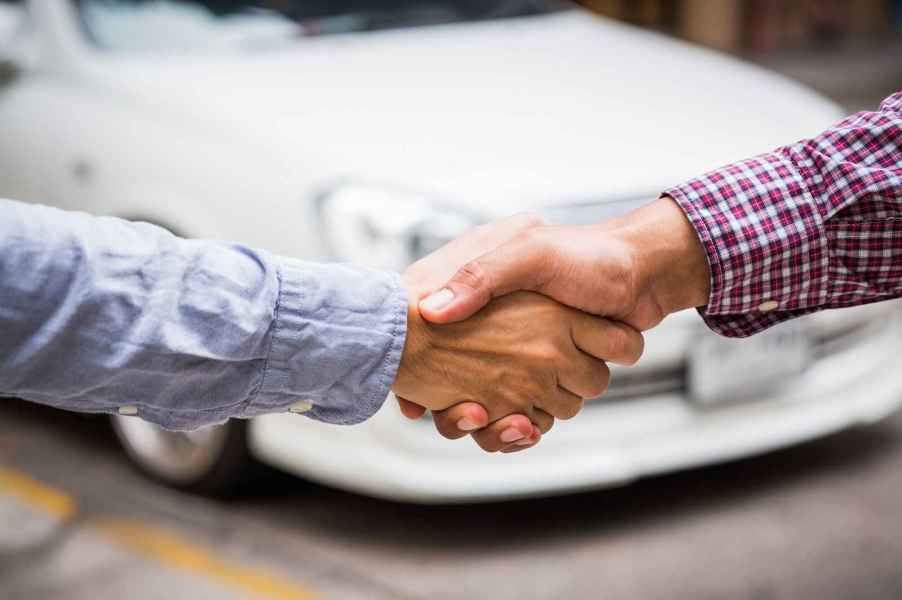 Hands shaking over a used car deal