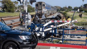 the scene of a train wreck with an SUV
