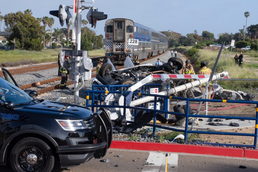 the scene of a train wreck with an SUV