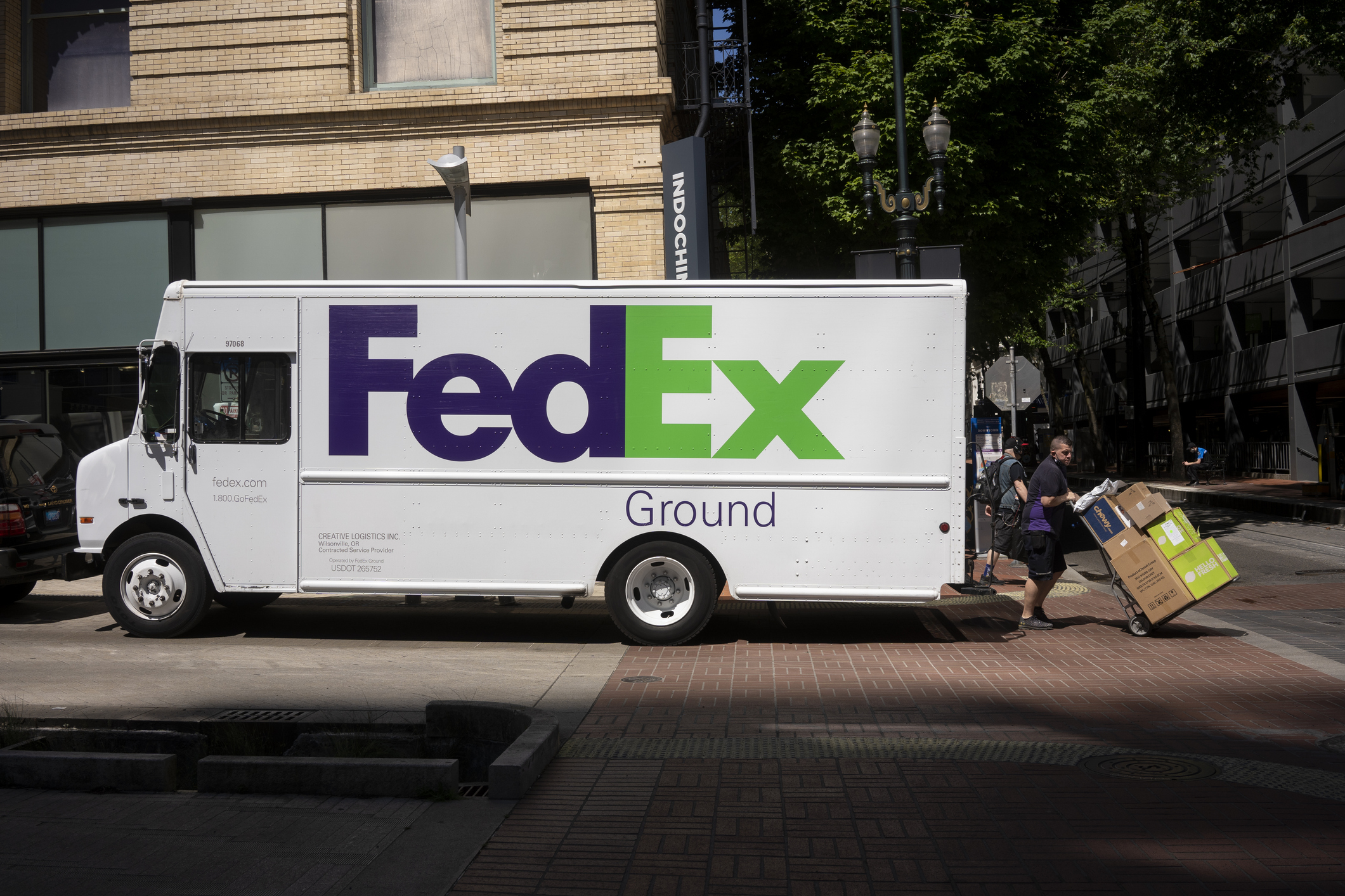 A FedEx truck driver delivering packages 