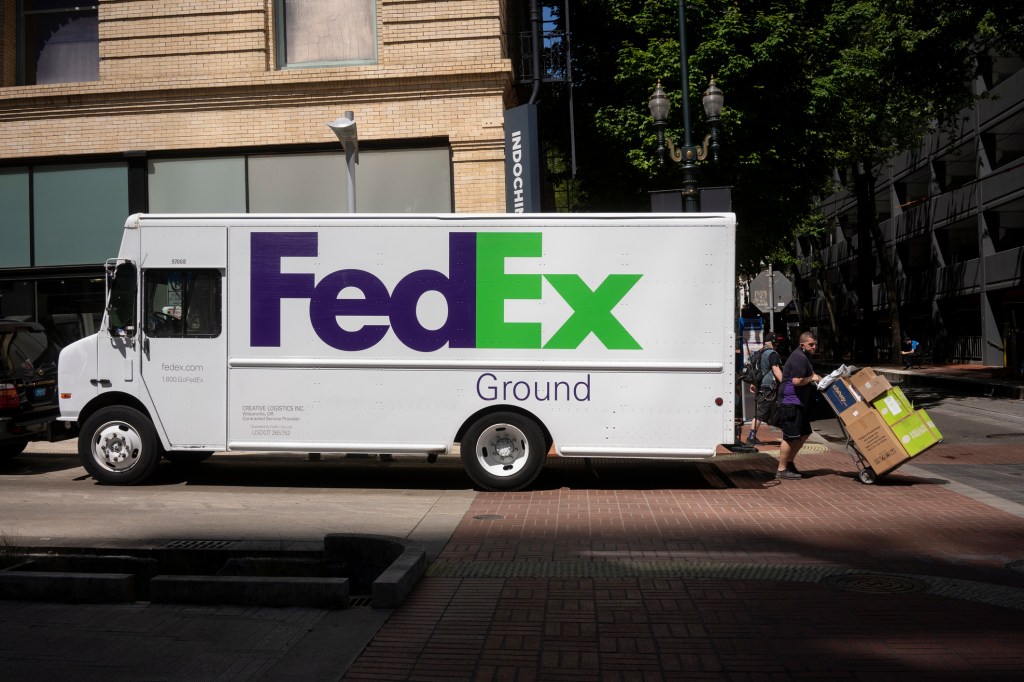 A FedEx truck driver delivering packages