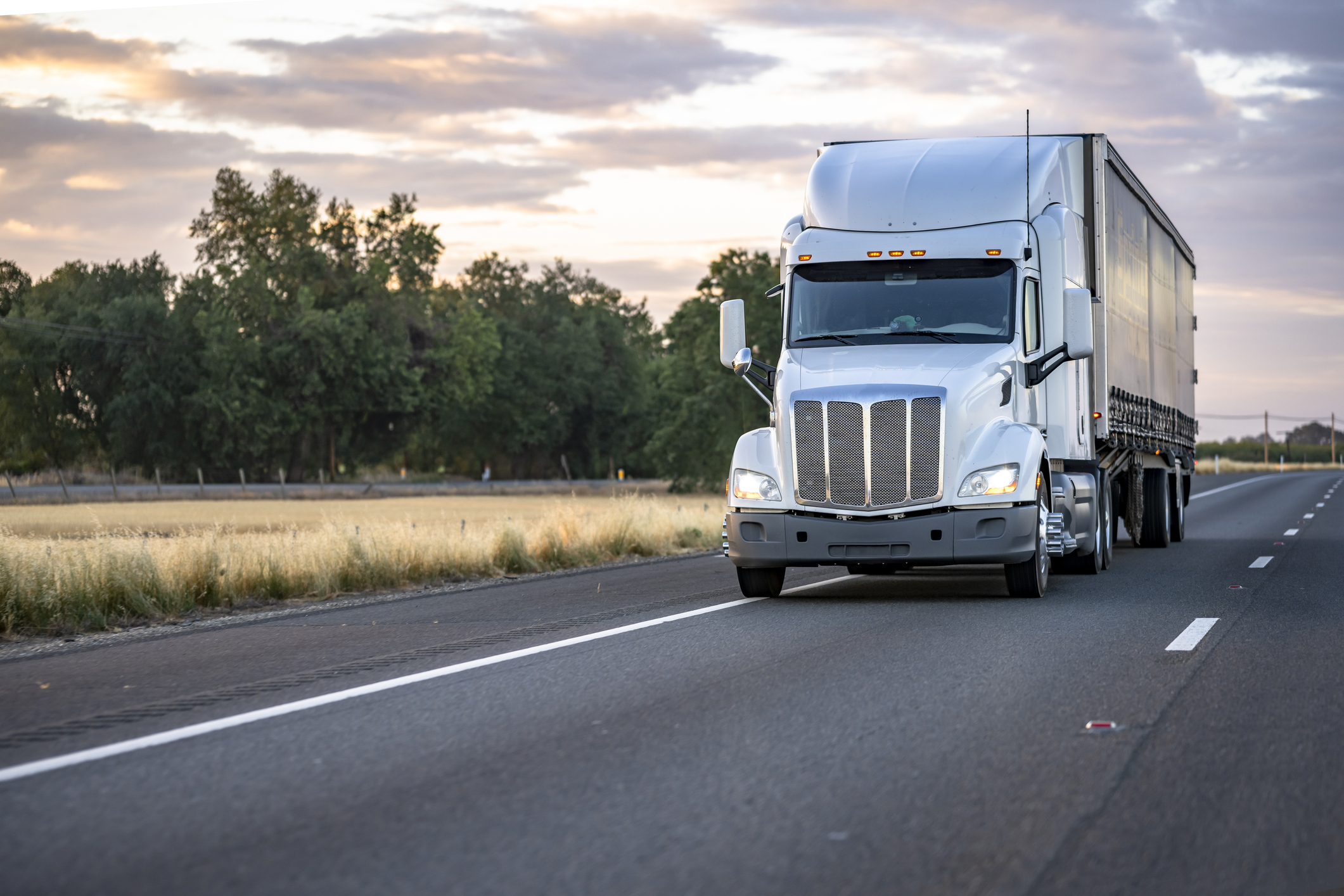 A white semi-truck on the road