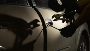 A car thief breaking into a truck