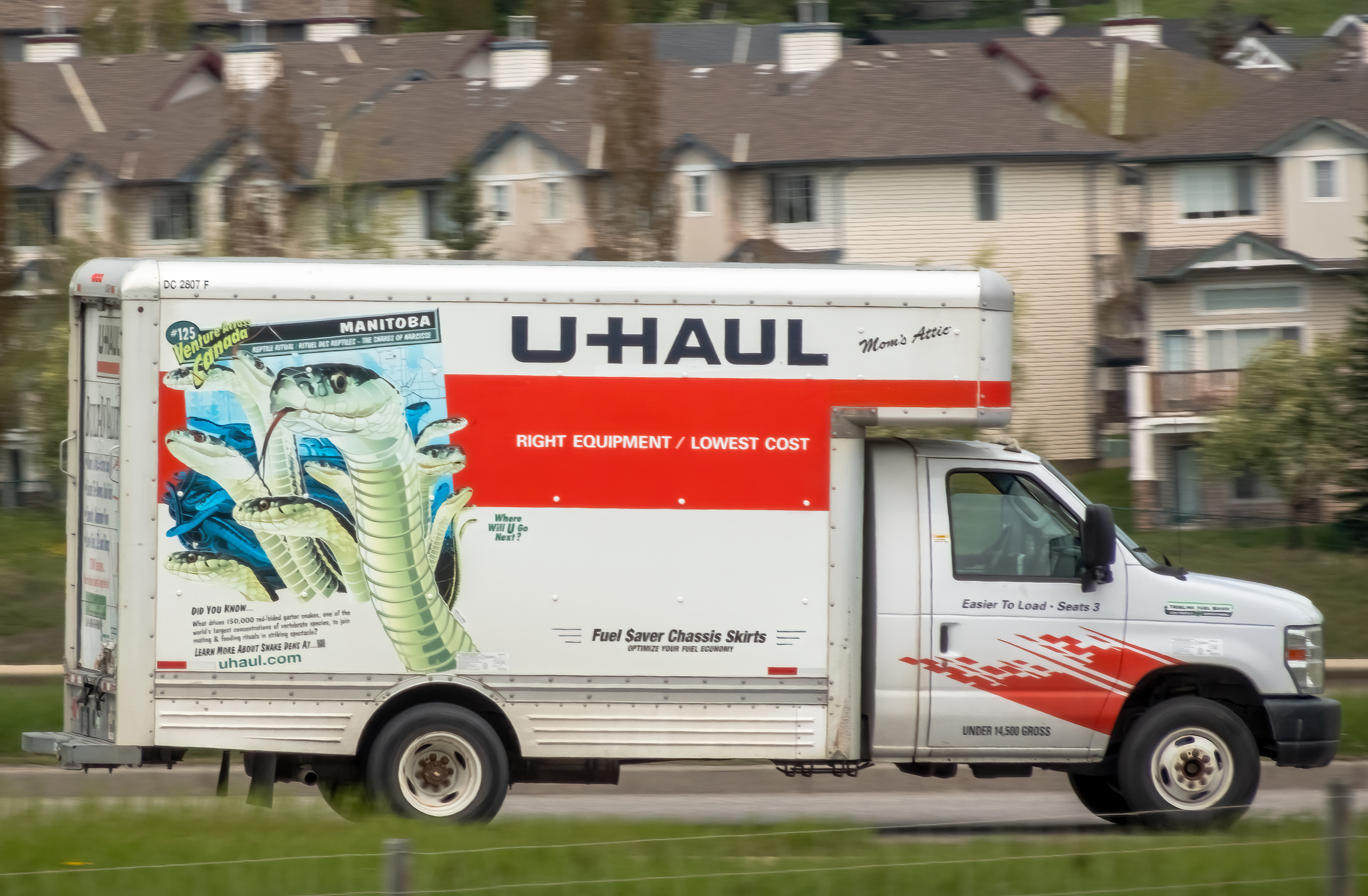 A U-Haul truck parked near apartments 