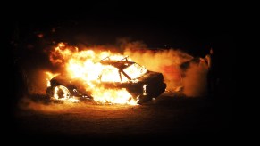 A car on fire at night