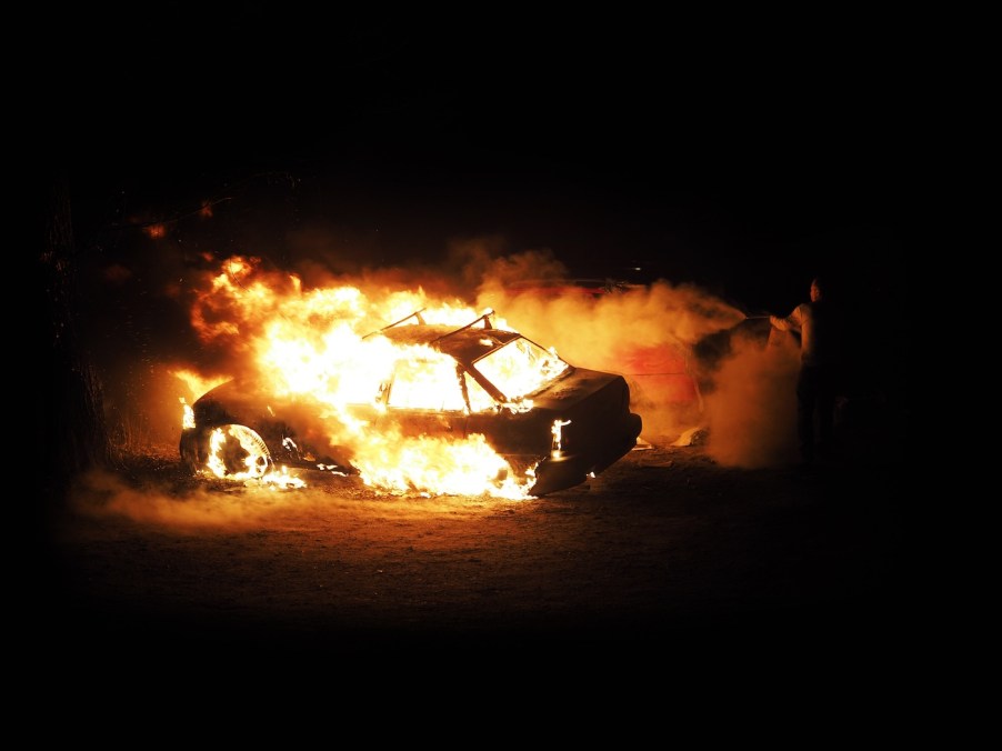 A car on fire at night