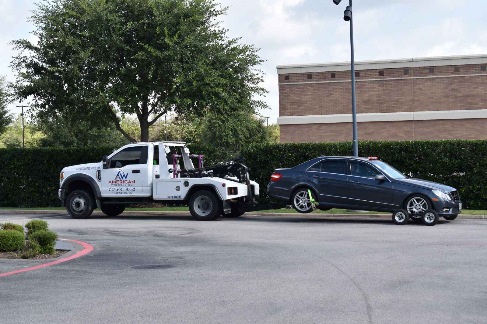 A Mercedes being towed away by a tow truck