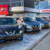 A Nissan dealership with cars on display for cuistomers