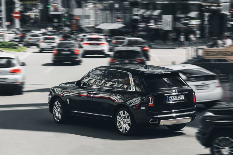 A Rolls Royce Cullinan being driven at speed