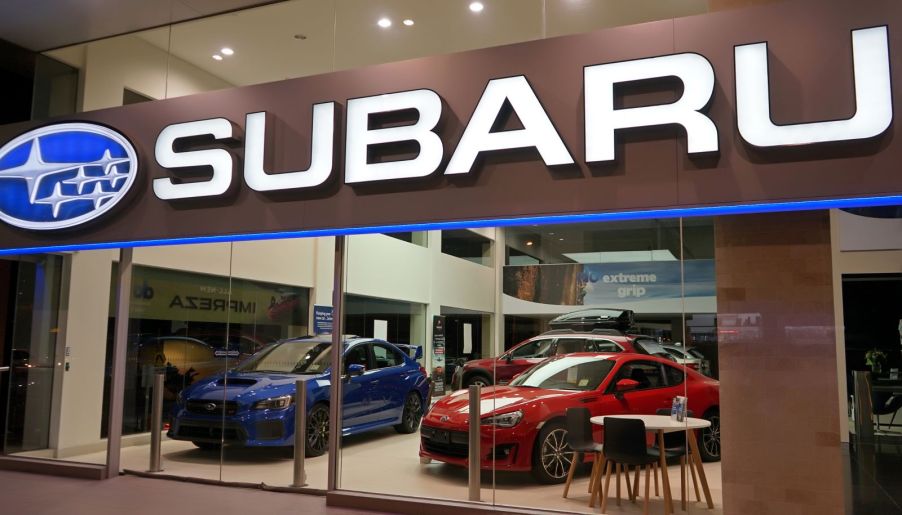 The storefront of a Subaru dealership with large glass doors to showcase vehicles on the showroom floor