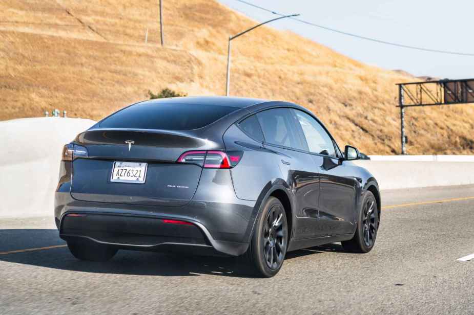 A Tesla Model Y driving down the highway