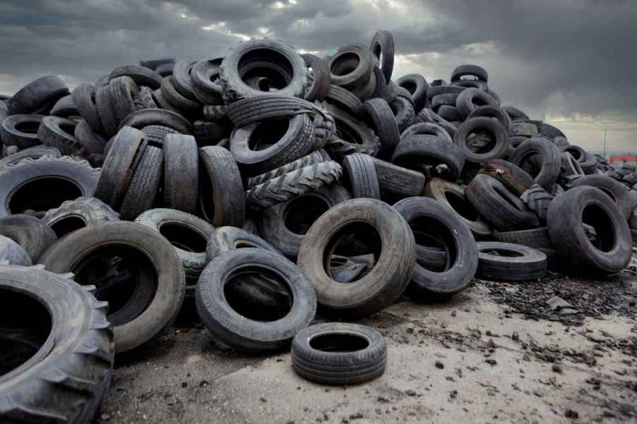 A large amount of discarded tires in the dirt