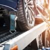 A car strapped to a flatbed tow truck