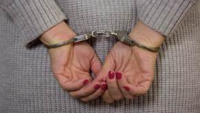 Police arrested a woman and put her in handcuffs.