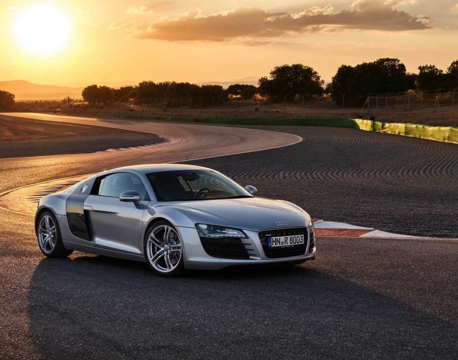 An Audi R8 supercar at track during a sunset.