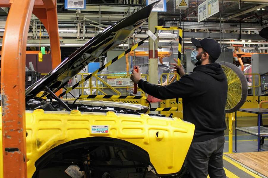 A worker builds American muscle cars like the Dodge Challenger at the Brampton Assembly Plant in Canada.