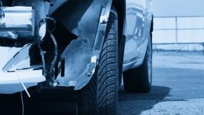 Silver bumper smashed up after a car crash.