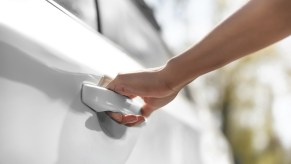 Driver trying to open a stuck car door.