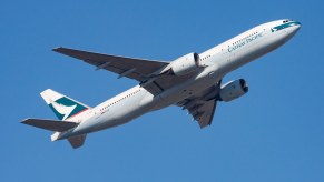 A Cathay Pacific flight takes off to fly to LAX.