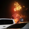 A car and an SUV are near fireworks, which can light a car on fire in seconds if participants aren't careful.
