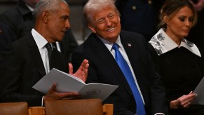 Trump sitting beside Obama