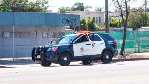 An LAPD SUV responds to LA crime on the side of a busy road.