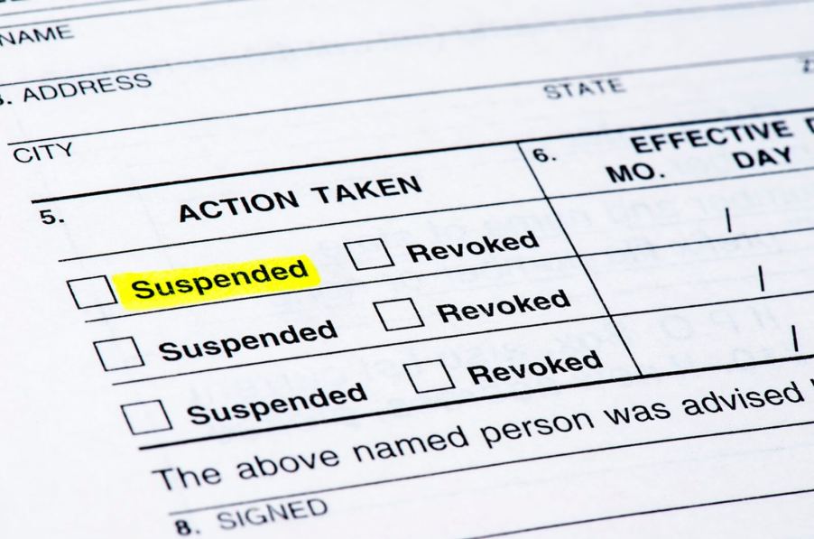 A document shows a suspended driver's license following a DUI charge.