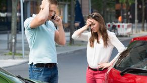 Two people stand around after an accident.