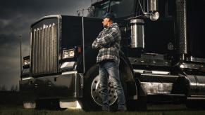 An American semi-truck parked next to the driver in close front end view