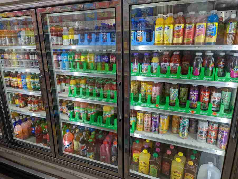 Drinks inside a glass-front commercial refrigerator at a gas station