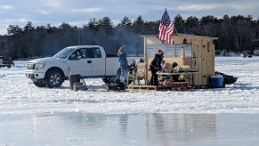 A truck parked on a frozen lake