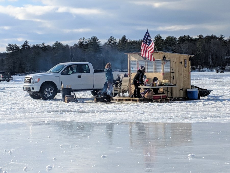 A truck parked on a frozen lake