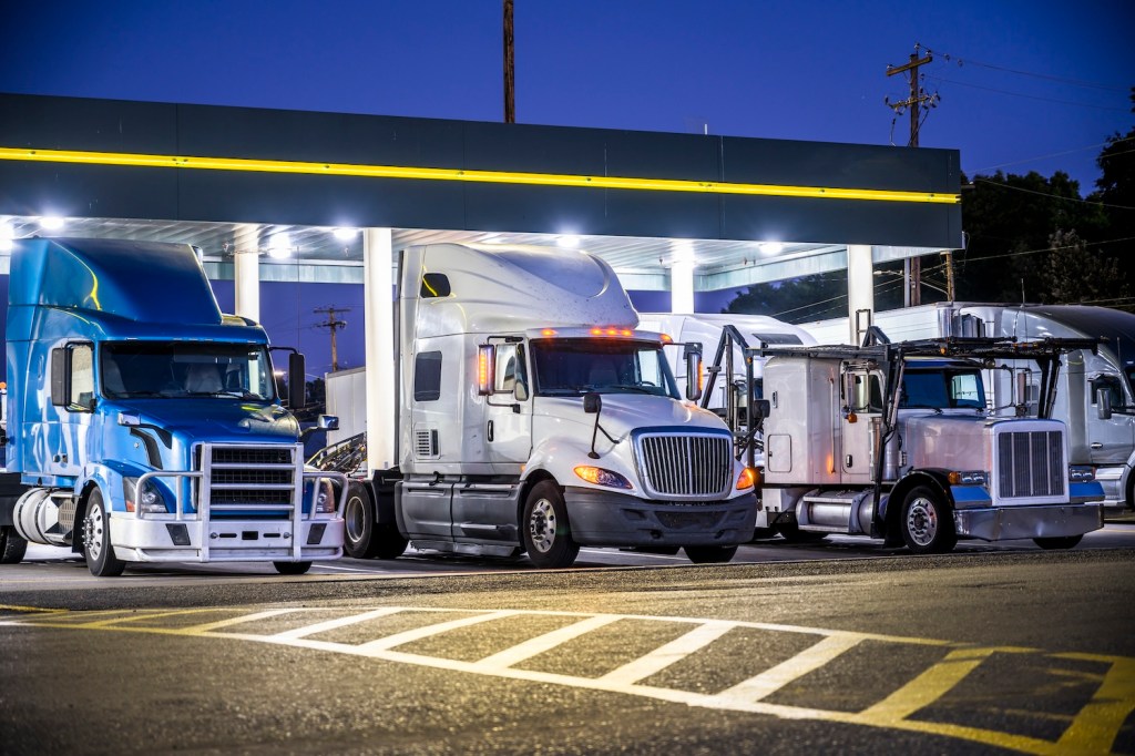 Trucks at fueling stations a truck stop