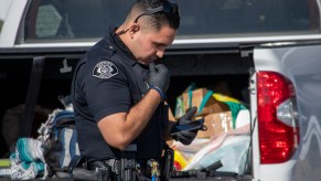 A police officer inspecting a truck