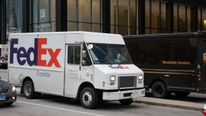 A FedEx truck on the road in the city
