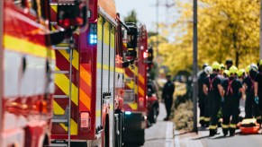 Fire trucks lined up by firefighters