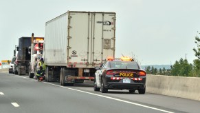 A semi-truck being pulled dover by the police