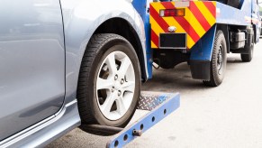 A car being picked up by a tow truck
