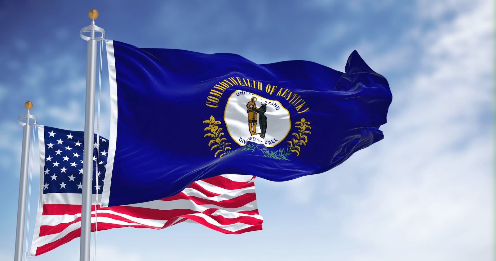The blue kentucky state flag in front of the U.S. national flag