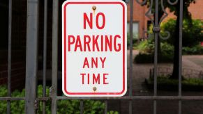 A sign on a private gate that reads "No Parking Any Time"